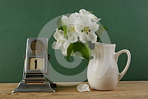 Old calendar and bird cherry branch in a jug