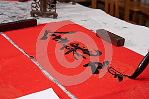 An old calligrapher writes couplets during the Chinese Year of the Dragon.