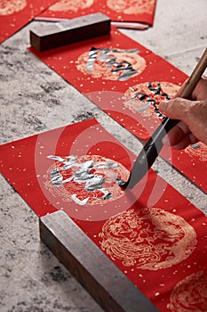 An old calligrapher writes couplets during the Chinese Year of the Dragon.