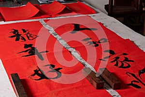 An old calligrapher writes couplets during the Chinese Year of the Dragon.