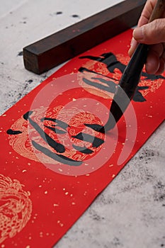 An old calligrapher writes couplets during the Chinese Year of the Dragon.