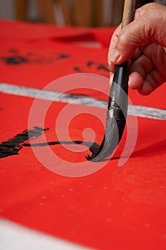 An old calligrapher writes couplets during the Chinese Year of the Dragon.