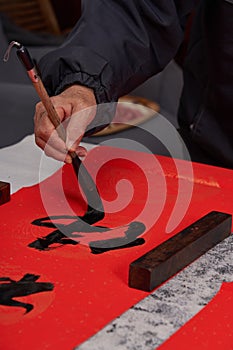 An old calligrapher writes couplets during the Chinese Year of the Dragon.