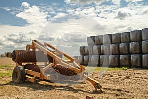 Old cambridge arable roller with bales of hay