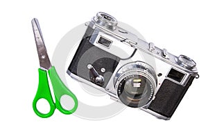 Old camera isolated with green scissors