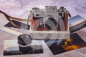 Old camera, old lens, color photos, photo album on the table. World Photography Day, August 19