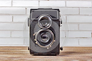 Old camera retouching Vintage on wooden table. Retro camera with two lenses