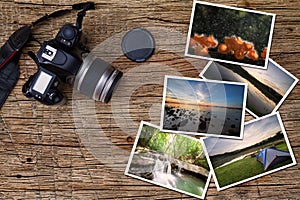 Old camera and stack of photos on vintage grunge wooden background