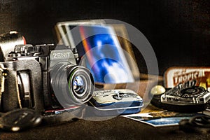 Old camera on a table with pictures and old lightmeter