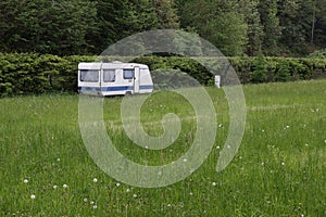 Old camper trailer standing at the edge of the forest, near Savinja river. Slovenia, Europe