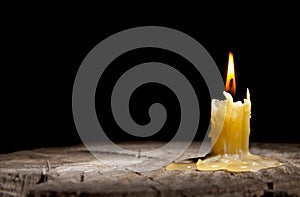Old candle on the black background