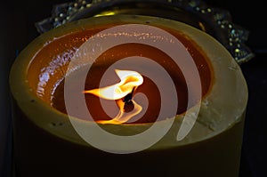 Old candle on the black background