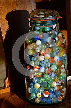 Old canning jar full of colorful marble