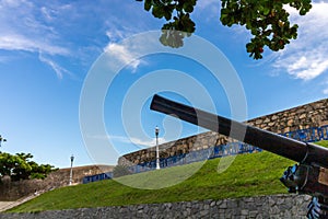 Old cannon with blue sky and white clouds in the background photo
