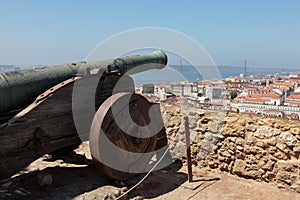 Old Cannon at Castelo de Sao Jorge, Aerial view of Lisbon and 25th April Bridge, Portugal.