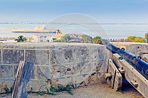 Old cannon in Diu Fort and view of Pani Kotha - old Diu Prison