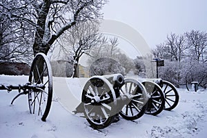 The old cannon in the winter snow.