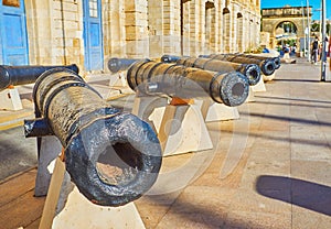 The old cannons in seaside promenade of Birgu, Malta