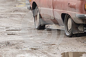 Old car on bad dangerous road.