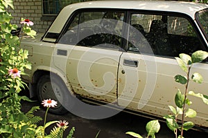 Old car with body damaged by rust.