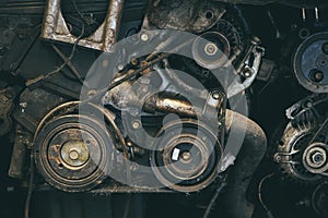 Old car engine spare part used closeup Serpentine belt vehicle machine dirty grease grunge with oil in garage