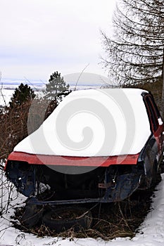 Old car parked near the forest