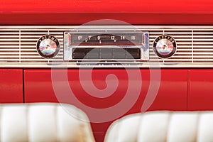 Old car radio inside a classic American car with chrome dashboard