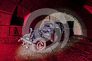 Old car rusting in an old ww2 shelter