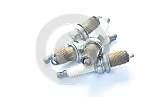 Old car spark plug arranging on white background