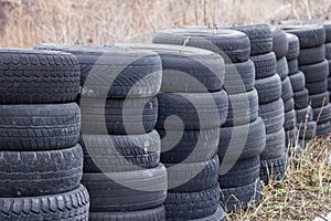 Old car tires stacked in a row