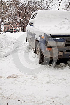 The old car under snow