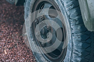 Old car wheel. Vintage car tires for offroad. Wheel of an old truck close-up.