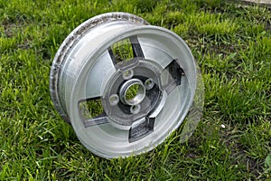 old car wheels titanium rims retro alloy on the street in green grass