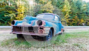 Old car wreck on a field