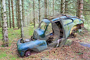 Old car wreck in the forest