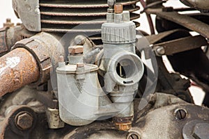 Old carburettor in the engine of an antique car