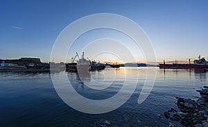 Old cargo vessels at a ship-breaker in the dawn