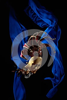 Old carnival masks with flutters blue cloth