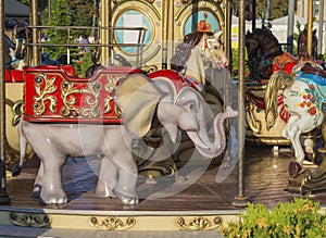 Old carousel colorful elephant in golden evening light