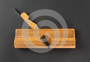 Old carpenter tool wood Plane on a gray