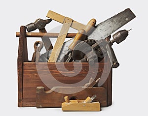 Old Carpenter Wooden toolbox with tools isolated on white