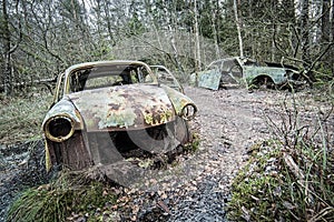 Old cars cemetery in forest