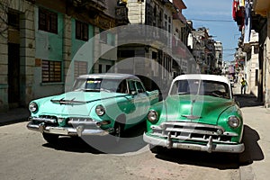 Old cars in downtown backstreet Havana photo