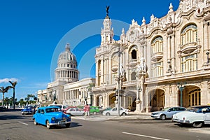 Old cars next to the Great Theater of Havana and the Capitol