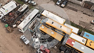 Old cars and public busses in the junkyard waiting to be