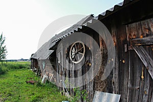 Old cart wheel hanged on wooden barn