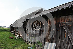 Old cart wheel hanged on wooden barn