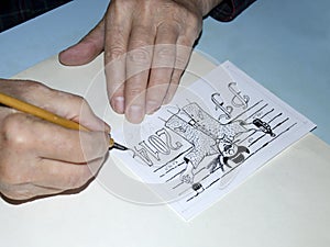 The old cartoonist hands drawing