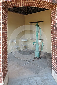 Old cast iron hand pump placed on the well