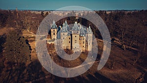 Old castle with a beautiful park in Goluchow, Poland. Historical monument. Travel in Europe. An aerial view drone photo in neutral